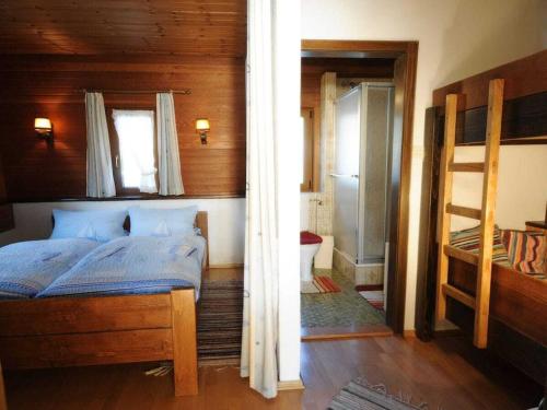a bedroom with a bed and a bunk room at 1-bedroom holiday home in Ludwigsthal