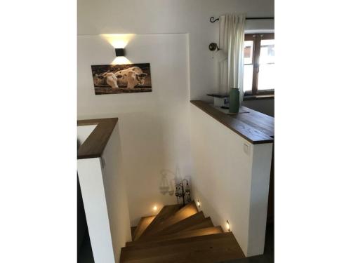 a staircase in a house with wooden floors at Chalet Hochgern in Staudach-Egerndach