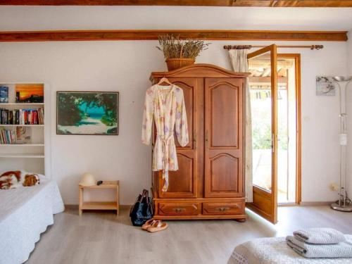 a bedroom with a large wooden cabinet and a bed at in southern France La Bastide in Saint-Julien-de-Peyrolas