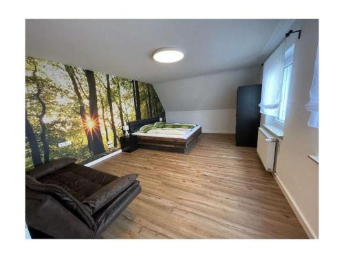 a living room with a couch and a bed at Holiday home with 2 bedrooms in Schopfloch