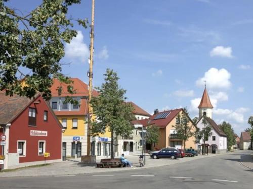 a street in a small town with a church at Holiday home with 2 bedrooms in Schopfloch