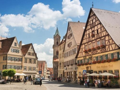 a group of buildings on a street with a church at Holiday home with 2 bedrooms in Schopfloch