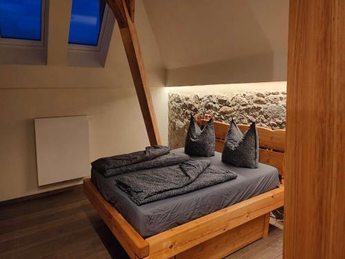 a bedroom with a bed with pillows on it at Lichtdurchflutetes Apartment mit Sauna & Kamin in Lauterbach