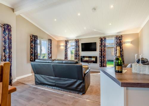 a living room with a couch and a table at Beaconsfield Park in Shrewsbury