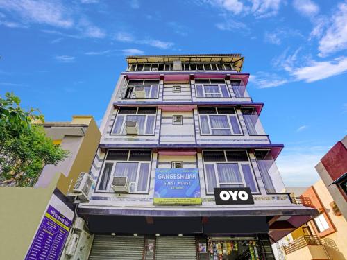 a tall building with a sign on it at OYO Flagship Hotel Gangeshwar in Anand