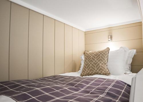 a bedroom with a bed and a pillow at Thirlestane Woodland Lodges in Lauder
