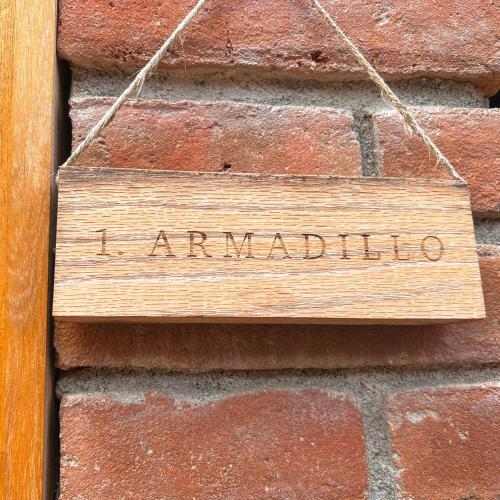 a wooden sign that reads i am madrid hanging on a brick wall at Casa Xaviera in Puerto Escondido
