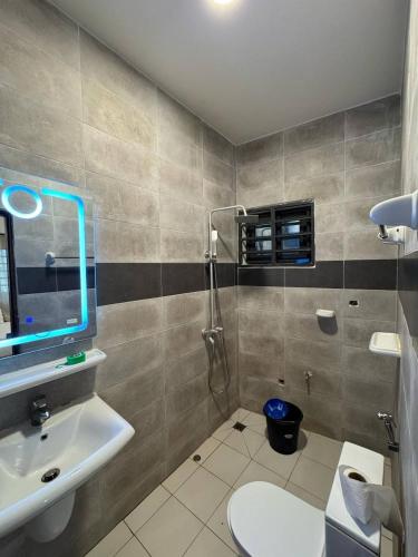 a bathroom with a shower and a toilet and a sink at Kwamba in Cotonou