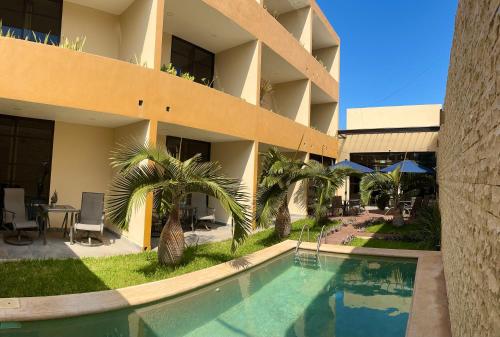 a hotel with a swimming pool in front of a building at Hotel Avila in Valladolid