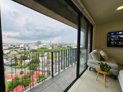 a balcony with a view of a city at Modern 2BR Condo in Providencia, City Views, Pool & Gym in Guadalajara