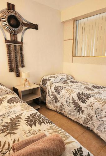 a bedroom with two beds and a window at Dptos en Consorcio Florentino in San Juan