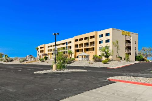 an empty parking lot in front of a building at Studio 6 Suites Lake Havasu City AZ in Lake Havasu City