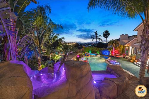 a pool at a resort at night with purple lights at Slide into Paradise, Pool, Spa & Stunning Views in San Diego