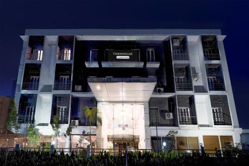 a building with a sign on the front of it at Super Townhouse Medavakkam Near Jayachandran in Chennai