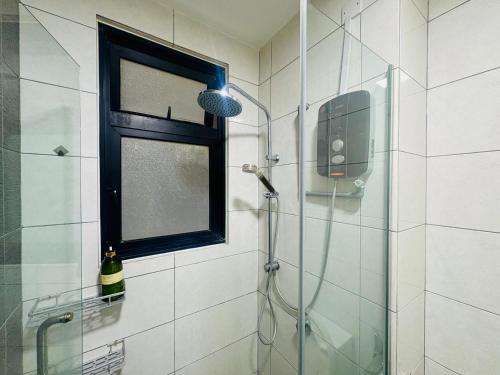 a shower in a bathroom with a window and a bottle of wine at Group-Friendly Stay in Putrajaya & IOI City Mall in Putrajaya