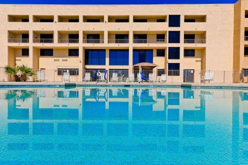 a swimming pool in front of a building at Studio 6 Suites Lake Havasu City AZ in Lake Havasu City