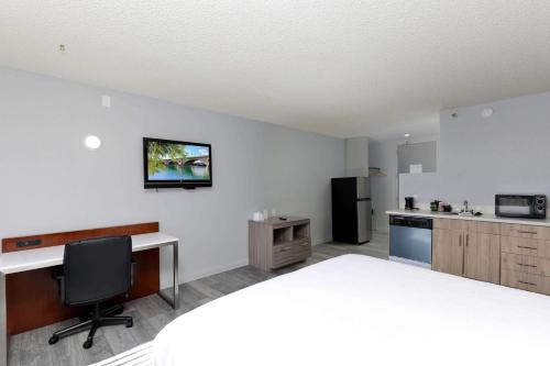 a kitchen with a desk and a computer in a room at Studio 6 Suites Lake Havasu City AZ in Lake Havasu City