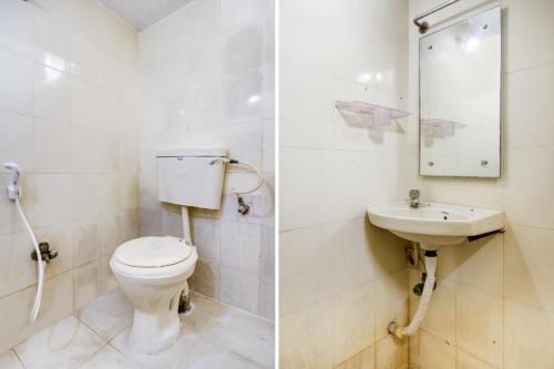 a bathroom with a toilet and a sink at Hotel O HAPPY RESIDENCY in Bībīnagar