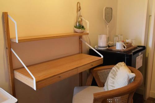 a room with a wooden shelf and a desk at Koho SXM - ex Hevea Hotel in Grand Case