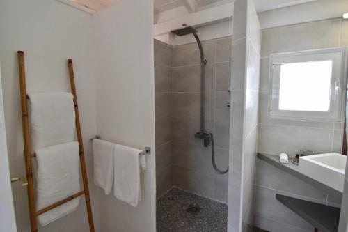 a bathroom with a shower and a sink at Koho SXM - ex Hevea Hotel in Grand Case