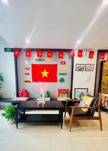 a room with a flag and a table and chairs at HOTEL TE AMO in Hai Phong