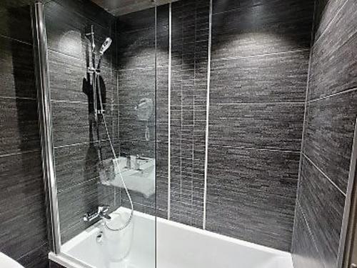a bathroom with a shower and a sink and a tub at Appartement au cœur des Gets, balcon sud-ouest, proximité pistes, wifi inclus - FR-1-598-130 in Les Gets