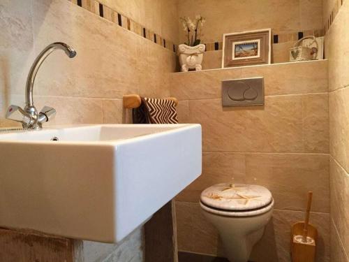 a bathroom with a sink and a toilet at Apartment in Zandvoort with swimming pool in Zandvoort