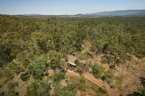an aerial view of a house in the middle of a forest at Mugul Dream Cottage by Tiny Away in Colosseum
