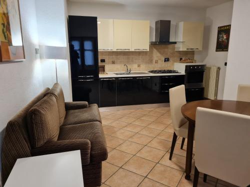 a living room with a couch and a table and a kitchen at Romantic Suite Privèe Oberje in Oulx