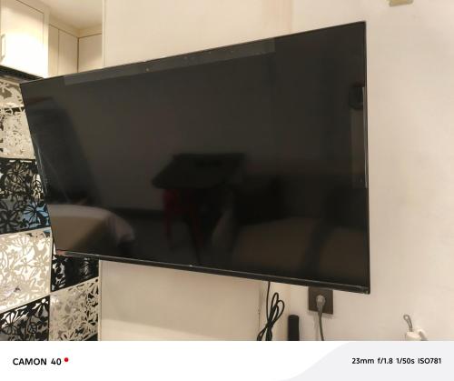 a large flat screen tv hanging on a wall at CBD Studio Loft 2A at City Center! in Medan