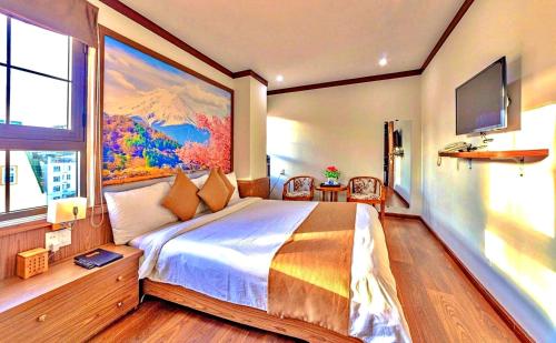 a bedroom with a large bed and a large window at S79 Residences Khai Ngoc Dalat in Da Lat