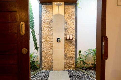 a fish tank in a hallway with a door at Good Karma House Ubud in Ubud