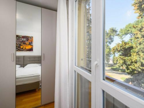 a window in a room with a bed and a window at Premium apartment Peschiera Porec in Poreč