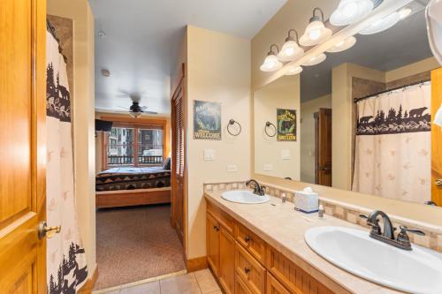 a bathroom with two sinks and a large mirror at Springs 8845 by Summit County Mountain Retreats in Snake River Health Services Incorporated Heliport