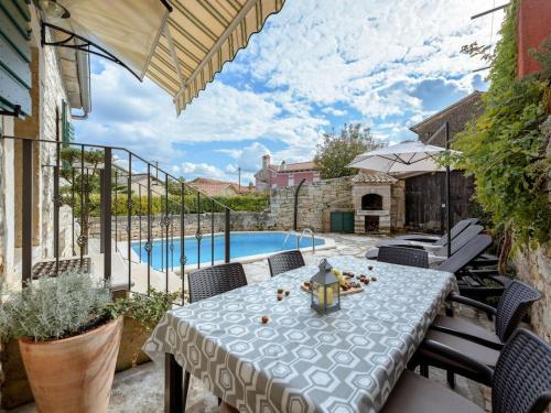 a patio with a table and a swimming pool at Villa in Tinjan with swimming pool in Tinjan