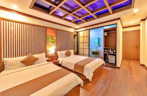a bedroom with two beds in a room with purple ceilings at S79 Residences Khai Ngoc Dalat in Da Lat