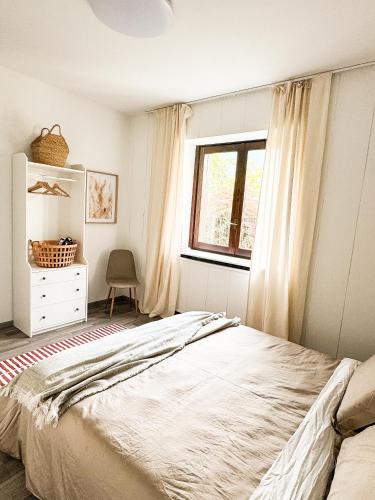 a bedroom with a large bed and a window at Il cuore della valtellina in Caiolo