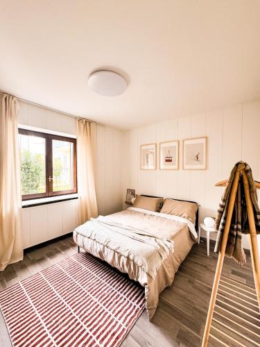 a bedroom with a bed and a large window at Il cuore della valtellina in Caiolo