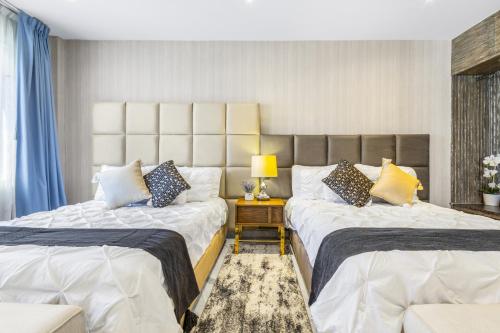 a bedroom with two beds and a lamp on a table at Nice Suite Close to El Medano beach and Nightlife in Cabo San Lucas