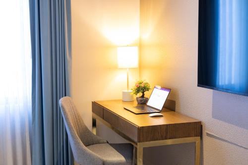a room with a desk with a laptop and a chair at Nice Suite Close to El Medano beach and Nightlife in Cabo San Lucas