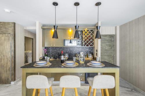 a kitchen with a large island with chairs and a table at Nice Suite Close to El Medano beach and Nightlife in Cabo San Lucas