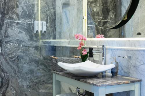 a bathroom with a sink on a marble counter at Nice Suite Close to El Medano beach and Nightlife in Cabo San Lucas