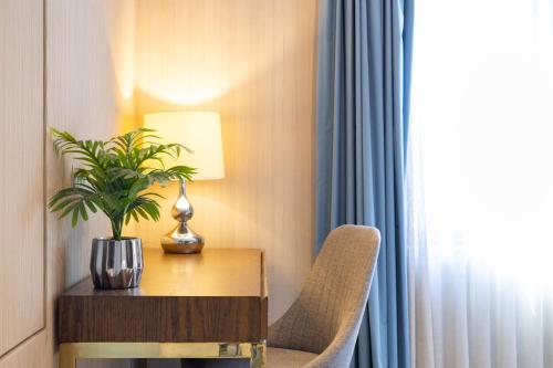 a hotel room with a table and a plant on it at Nice Suite Close to El Medano beach and Nightlife in Cabo San Lucas