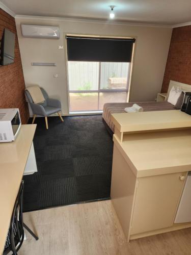 a hotel room with two beds and a window at Sun River Resort in Mildura