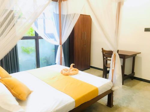 a bedroom with two beds and a window at Chathu Villa in Walgama South