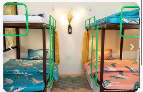 a room with two bunk beds in a room at Pao's Leisure Homestay in Ha Giang
