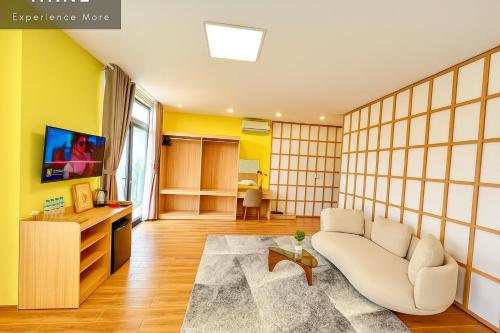 a living room with a couch and a tv at S79 PowerMia RiverFront Grand World in Phu Quoc