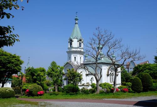 a white building with a tower on top of it at ステラサイト函館 in Hakodate
