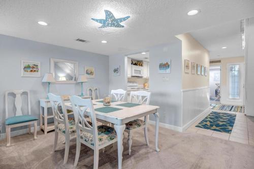 a kitchen and dining room with a table and chairs at Beachy Vibes in Ponte Vedra Beach
