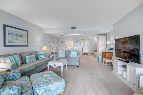 a living room with a couch and a tv at Beachy Vibes in Ponte Vedra Beach